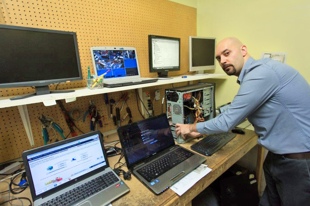 Certified computer technician working on computers in store