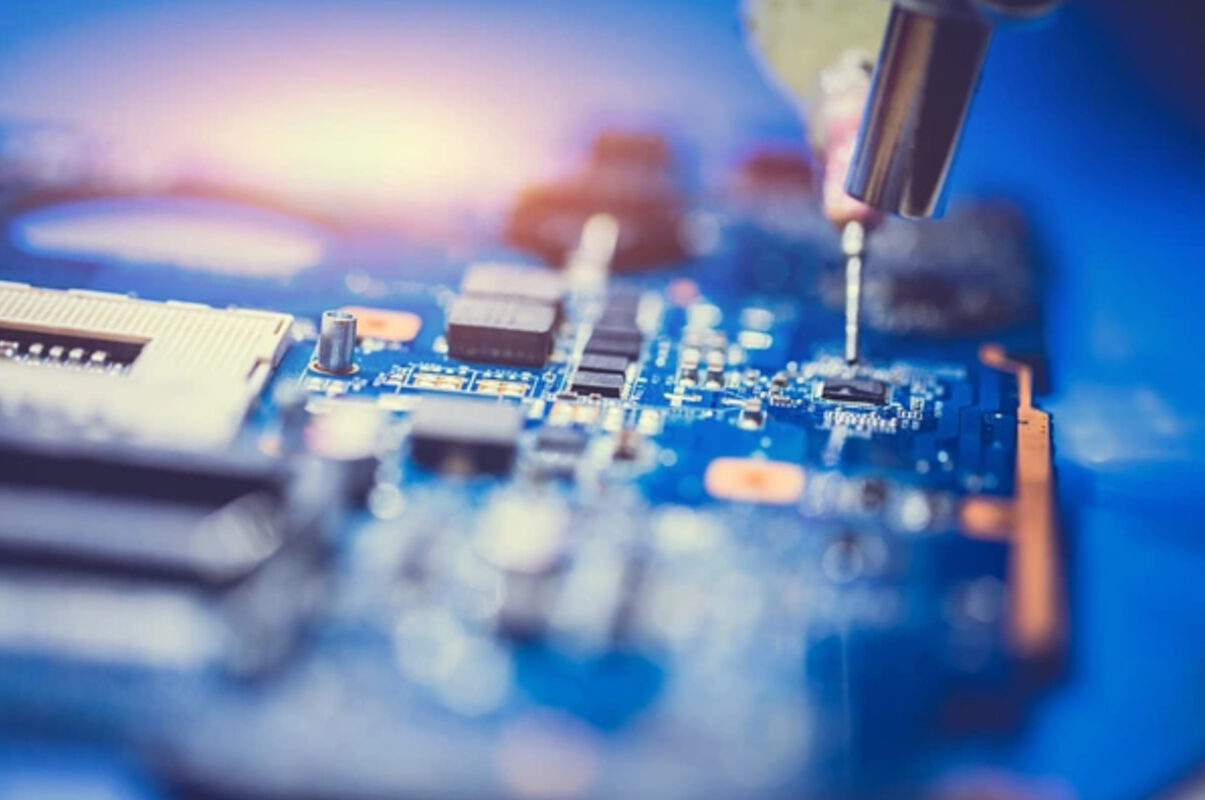 a closeup of a computer circuit being repaired